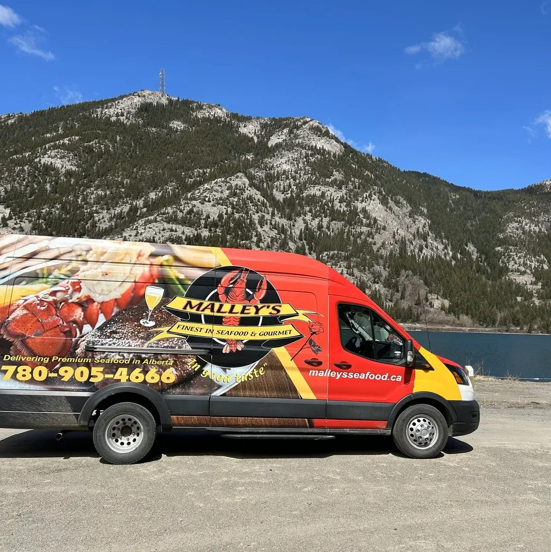 Malley's Seafood delivery truck parked near the mountains